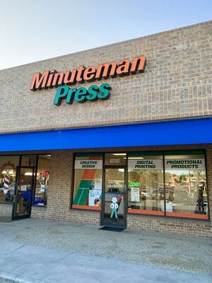 The shop's storefront at 16606 San Pedro Avenue, with creative design, digital printing and promotional products signs in the windows